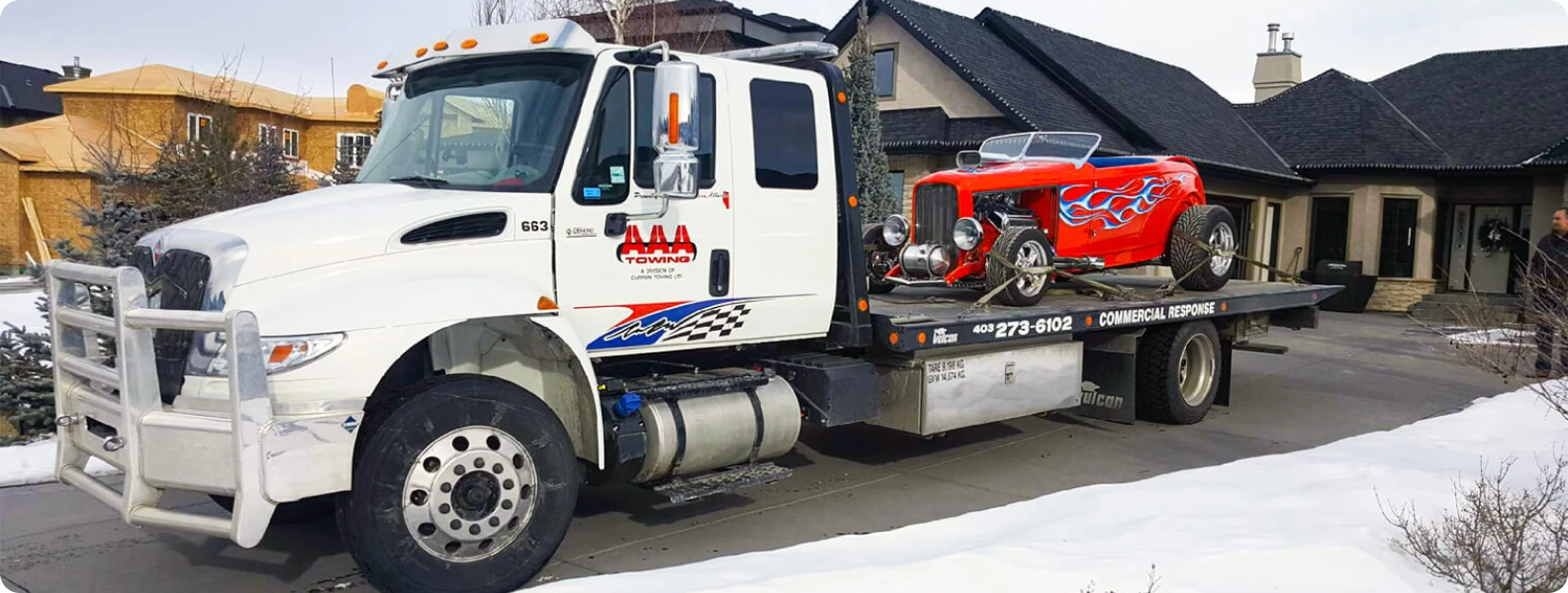 AAA Towing flatbed truck hauling a vehicle in Calgary